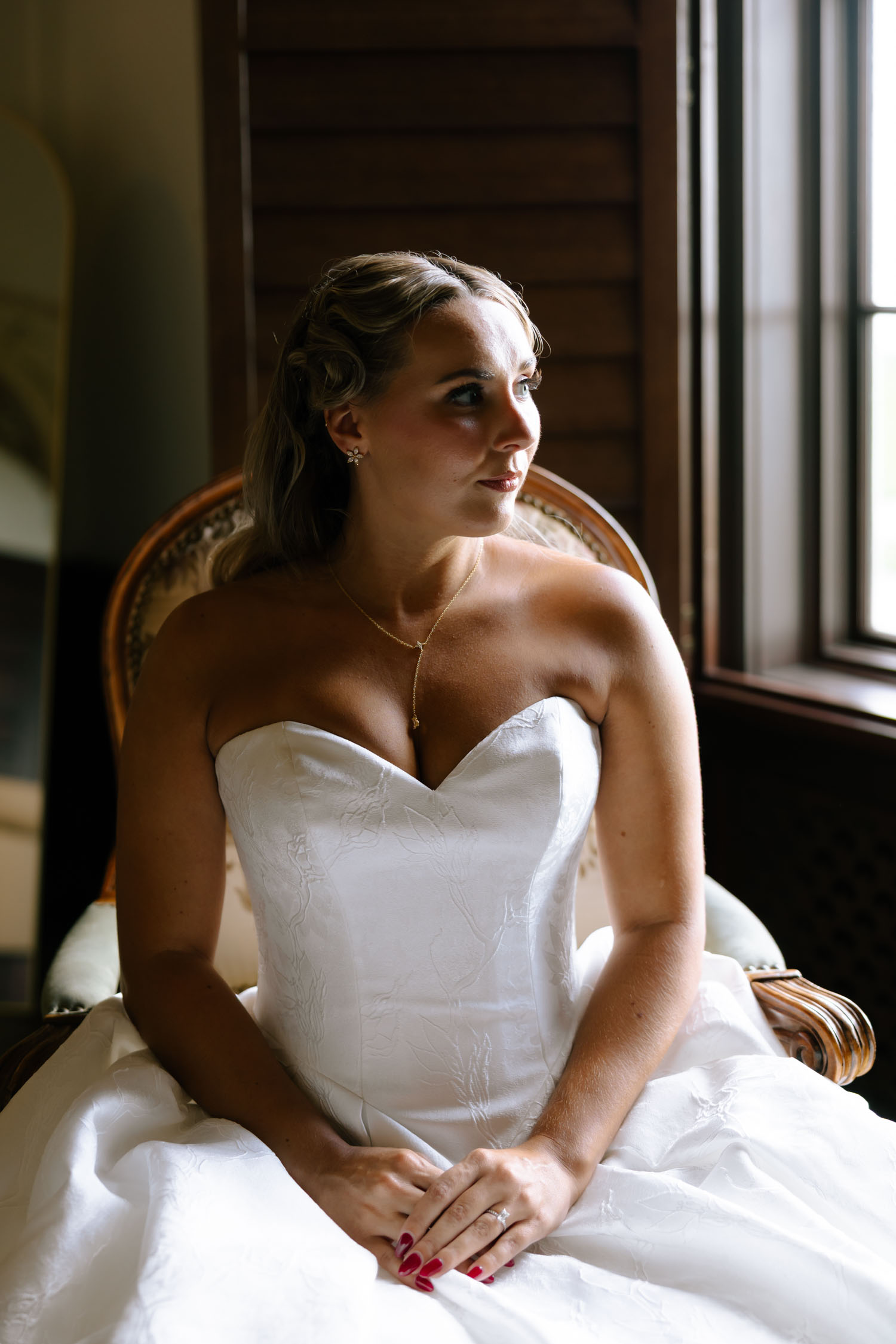 Elegant bride posing in chair for a bridal portrait at New College in Sarasota, Florida