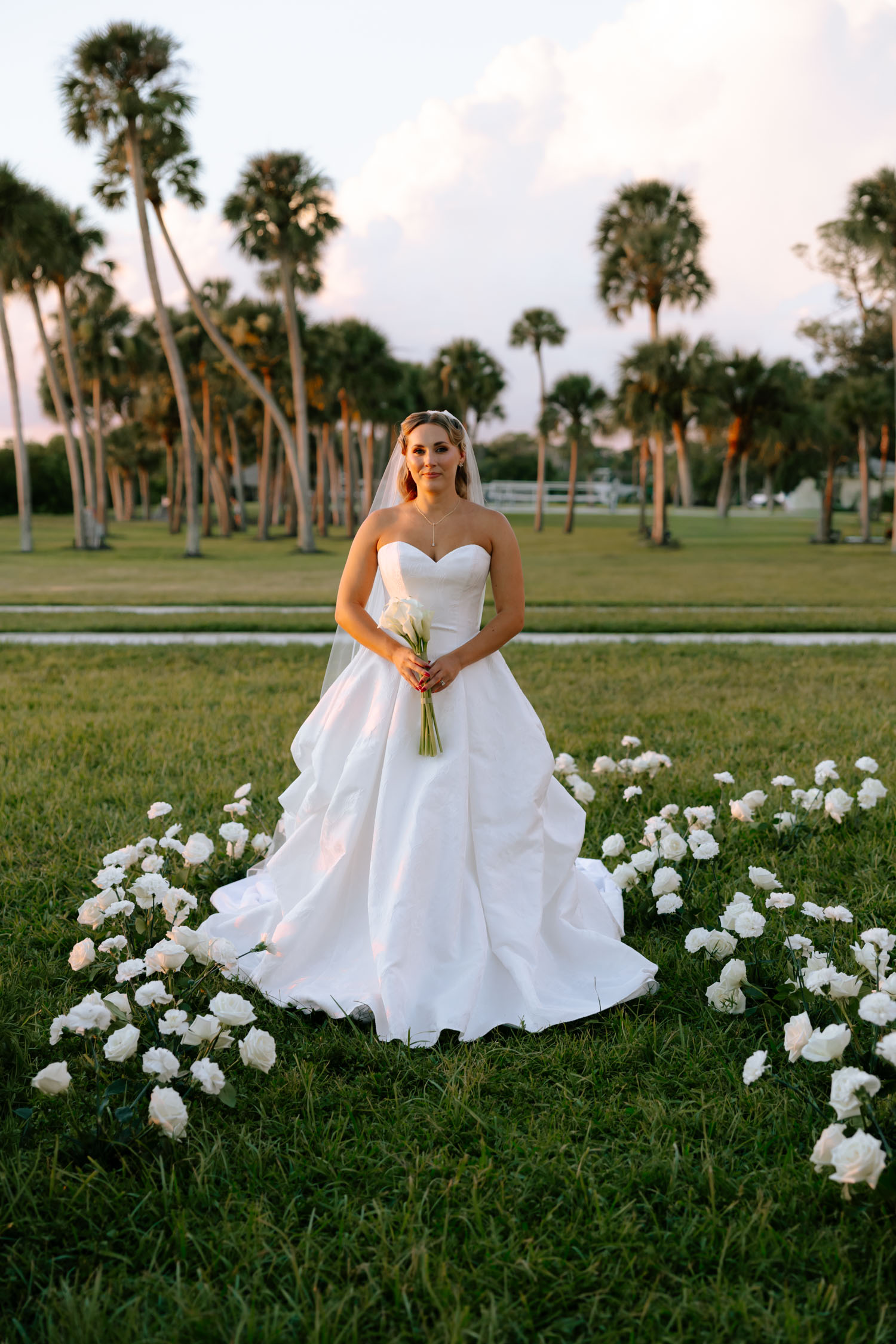 Bride walking fown floral-lined aisle at Sarasota wedding in New College